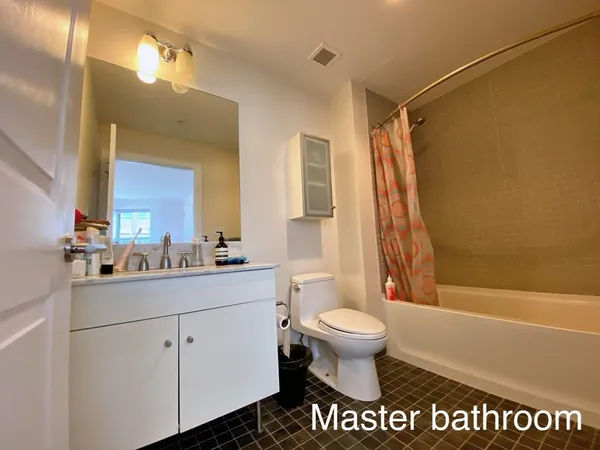 a bathroom with a sink a toilet a mirror and shower