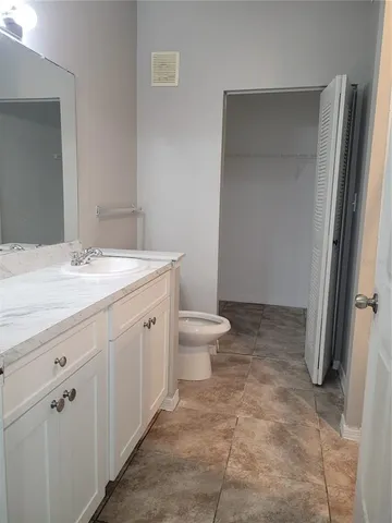 an empty room with fan and windows