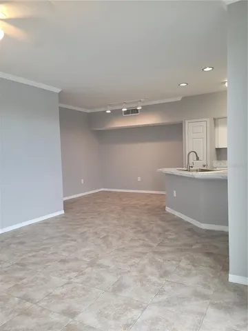a view of a kitchen with stainless steel appliances a sink and cabinets