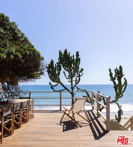 a view of balcony with wooden floor and seating space