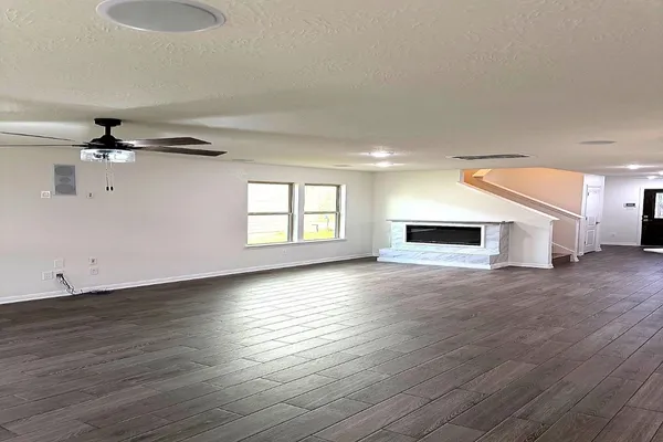 a view of a livingroom with wooden floor and a window