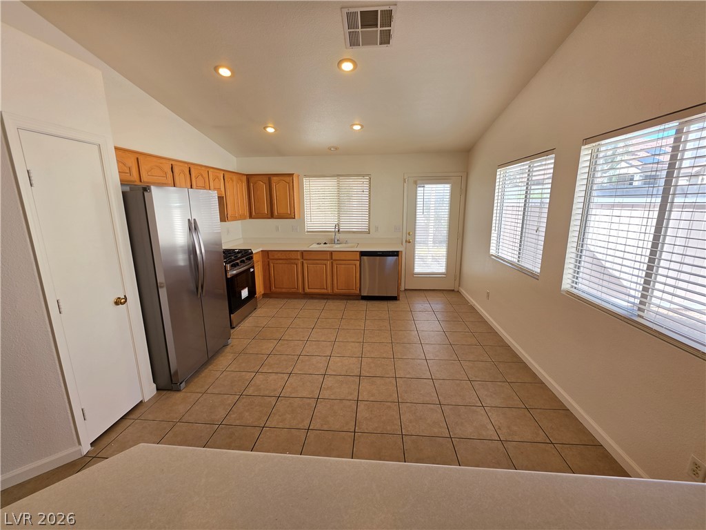 9609 Crystal Ridge Road Las Vegas, NV 89123 - Photo 5 of 21 An open kitchen area showcases practical tile flooring beneath recessed ceiling lights.
