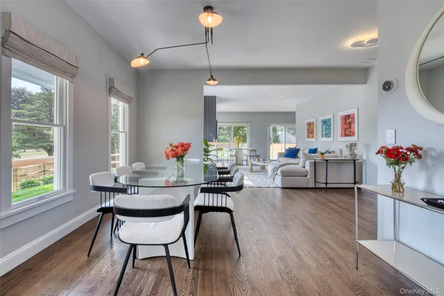 a view of a dining room with furniture and a chandelier
