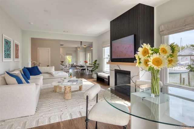 a living room with fireplace furniture and a potted plant