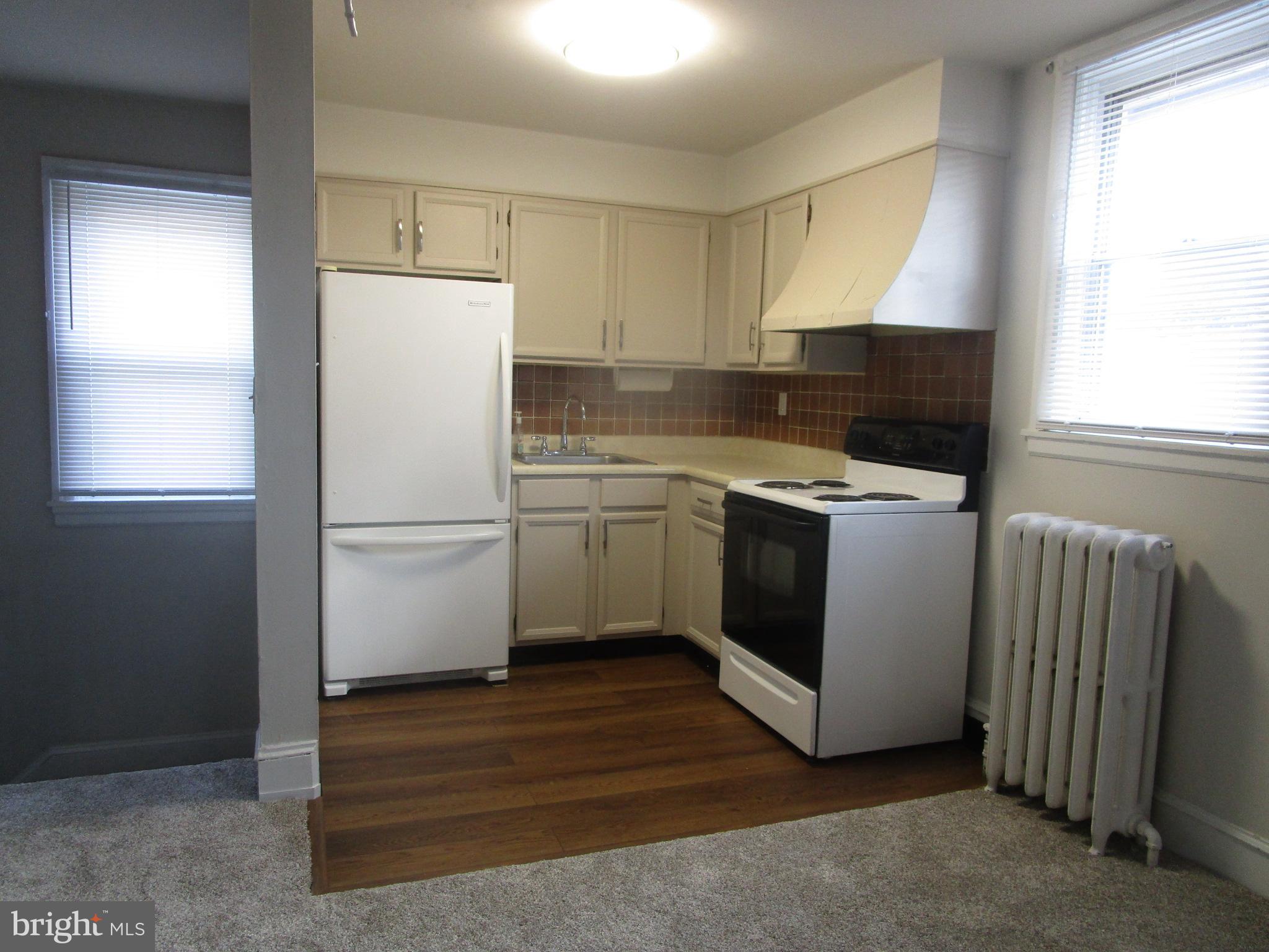 125 West Eagle Road, Unit 2 Havertown, PA 19083 - Photo 4 of 8 a utility room with cabinets washer and dryer