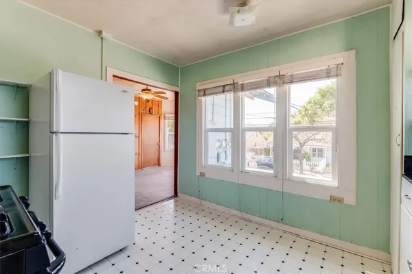 a kitchen with a sink window and cabinets