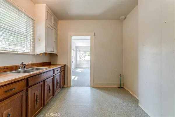 a kitchen with granite countertop a sink cabinets and window