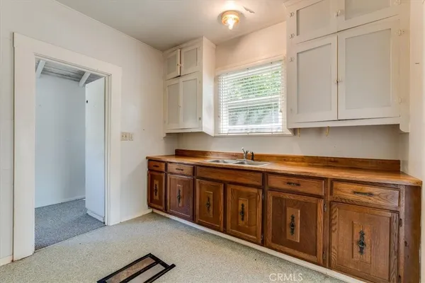 a kitchen with a refrigerator and a stove