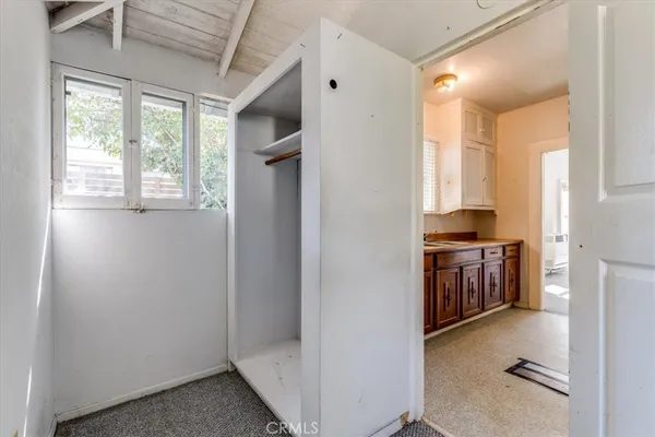 a view of a hallway with wooden floor and entryway