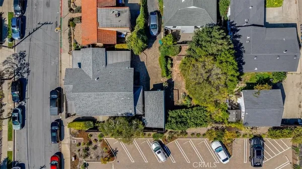 an aerial view of multiple houses with a city street