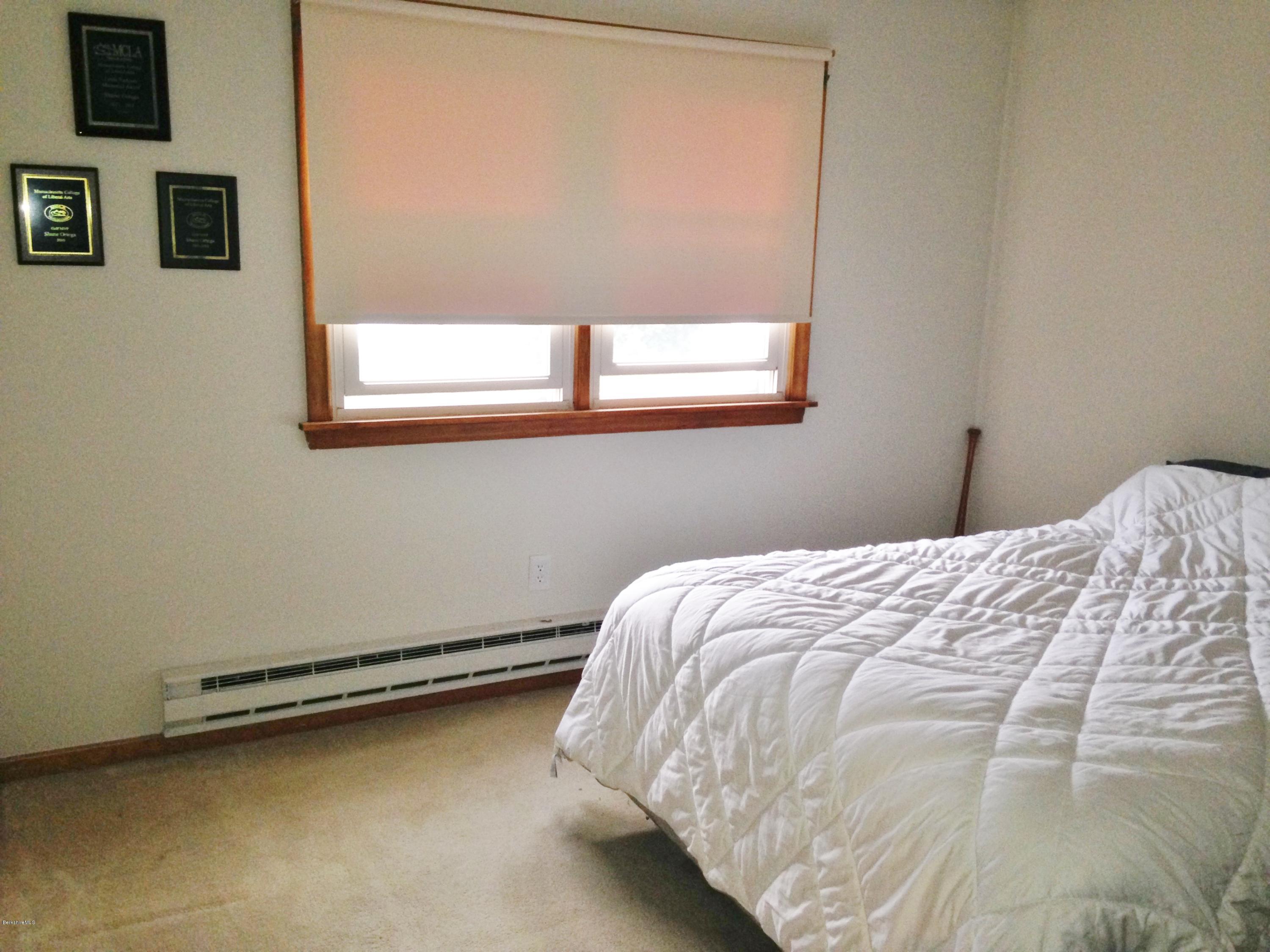 4 Onota Lane, Unit 2 Pittsfield, MA 01201 - Photo 11 of 17 a bed sitting in a bedroom next to a window