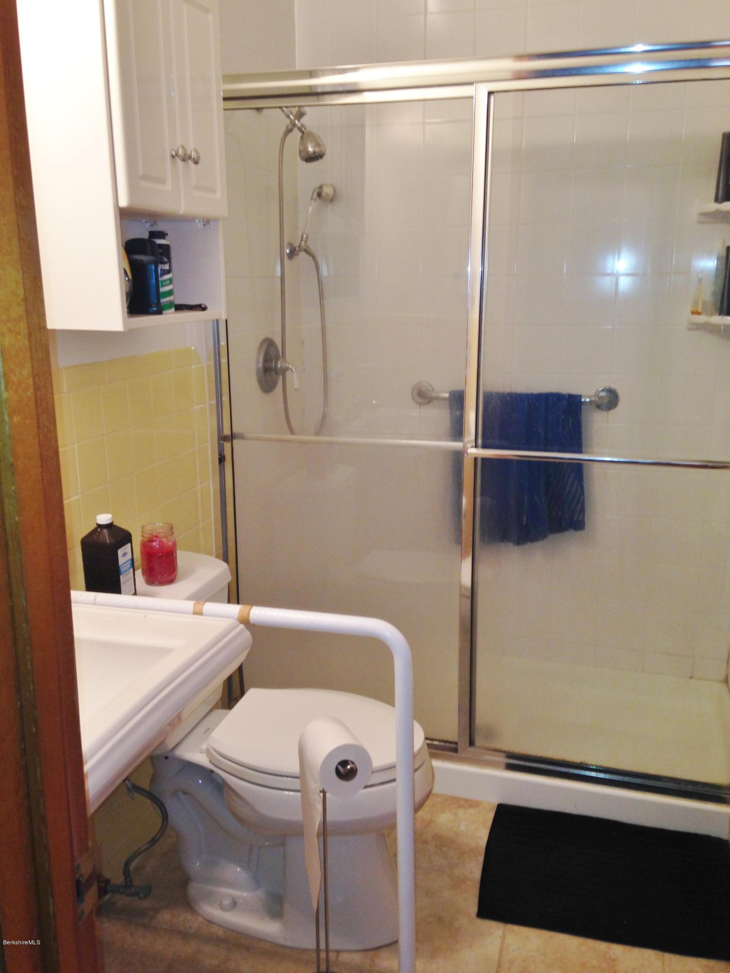 4 Onota Lane, Unit 2 Pittsfield, MA 01201 - Photo 13 of 17 a bathroom with a sink a toilet and shower