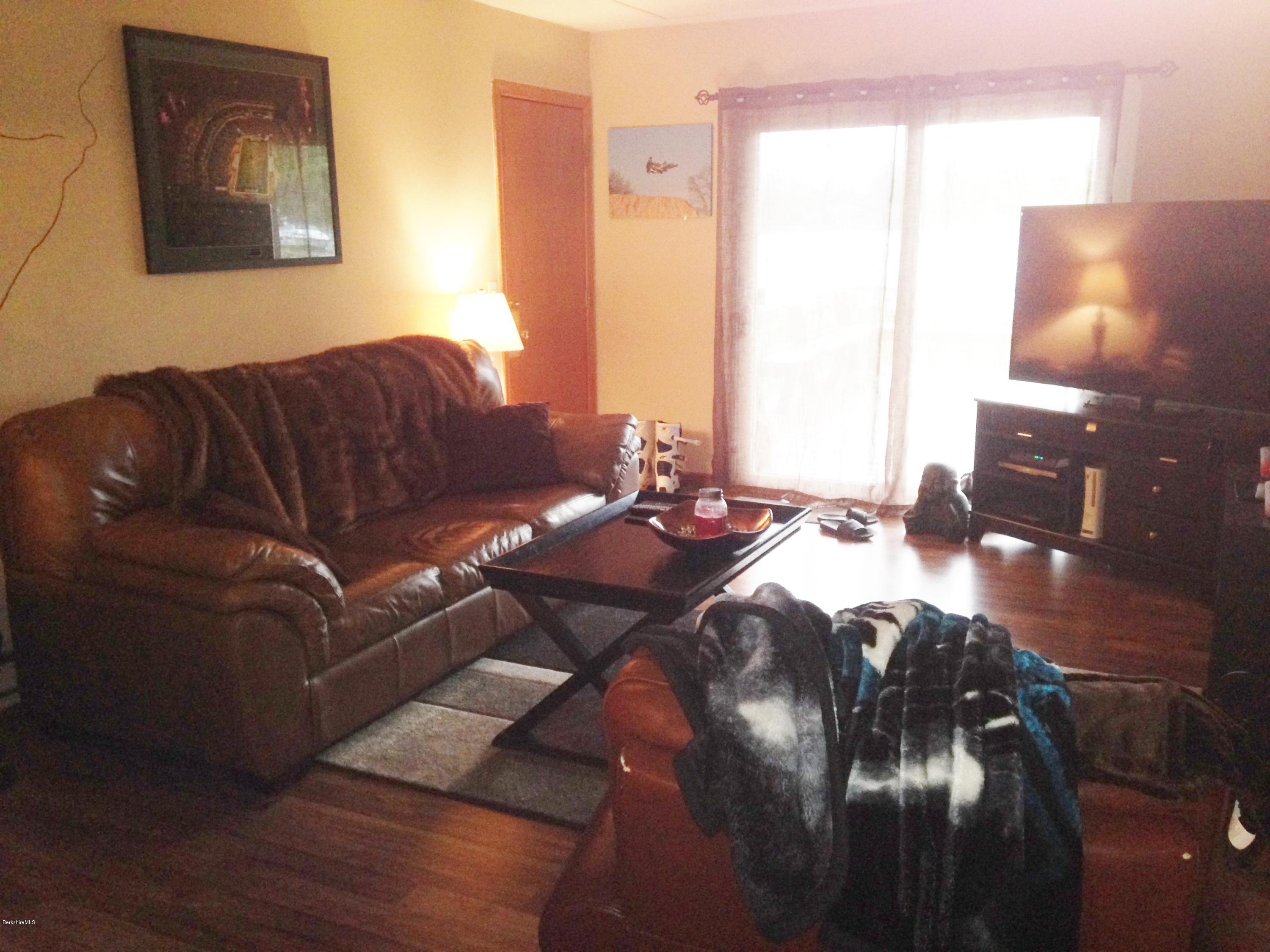 4 Onota Lane, Unit 2 Pittsfield, MA 01201 - Photo 3 of 17 a living room with a couch wooden floor and a table