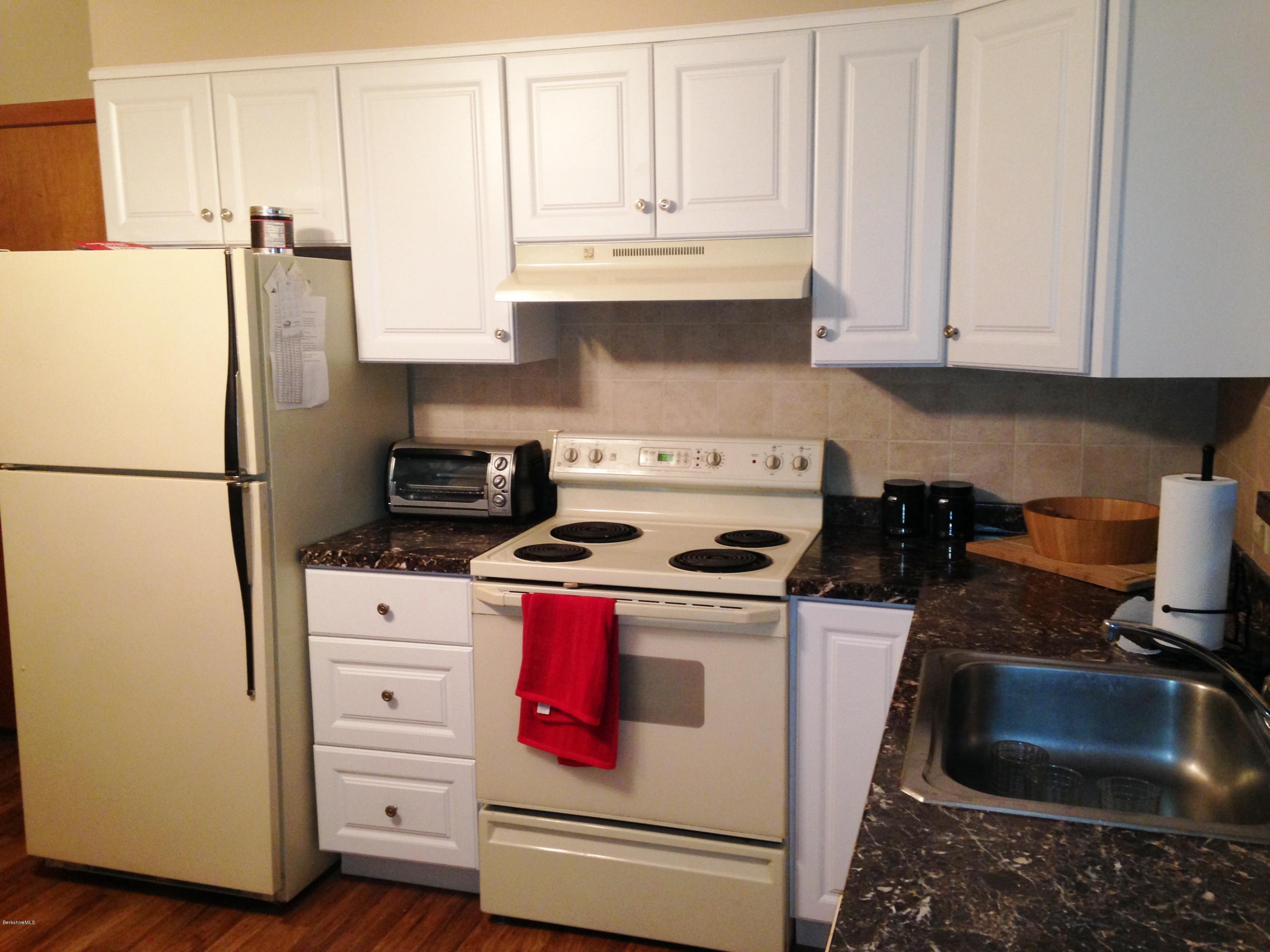 4 Onota Lane, Unit 2 Pittsfield, MA 01201 - Photo 5 of 17 a kitchen with granite countertop a sink stove and refrigerator
