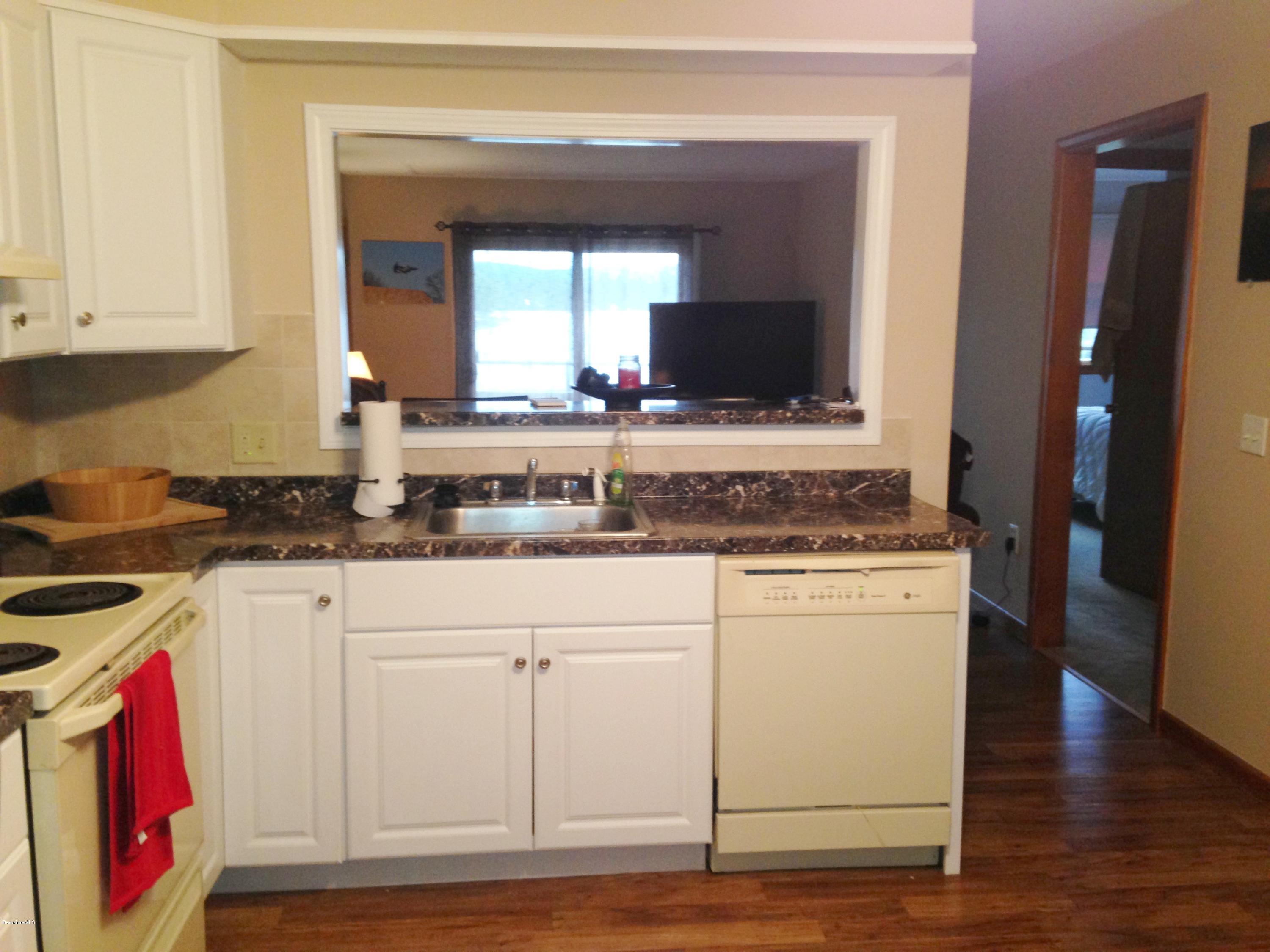 4 Onota Lane, Unit 2 Pittsfield, MA 01201 - Photo 6 of 17 a kitchen with stainless steel appliances granite countertop a stove and a sink