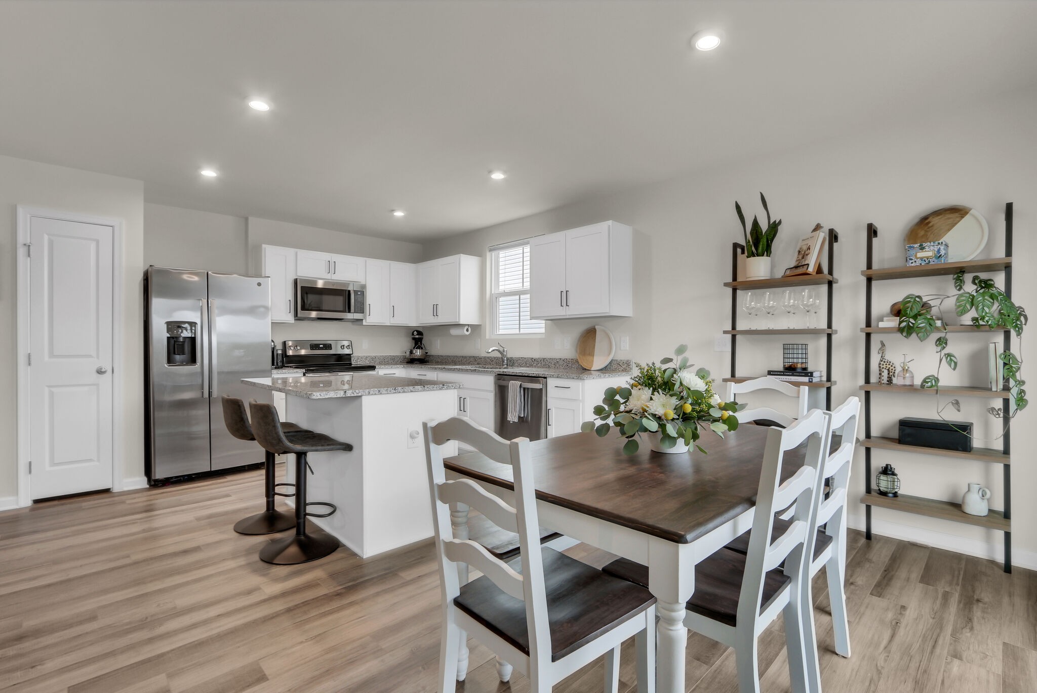 1732 Quail Run Way Spring Hill Spring Hill, TN 37174 - Photo 13 of 28 a kitchen with stainless steel appliances kitchen island granite countertop a dining table chairs and refrigerator