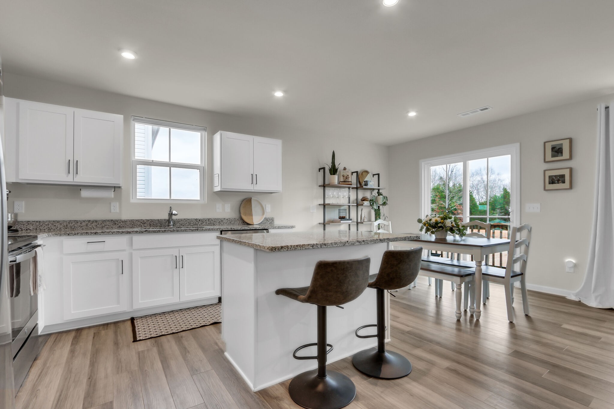 1732 Quail Run Way Spring Hill Spring Hill, TN 37174 - Photo 6 of 28 a kitchen with stainless steel appliances granite countertop a stove a sink a refrigerator and white cabinets with wooden floor