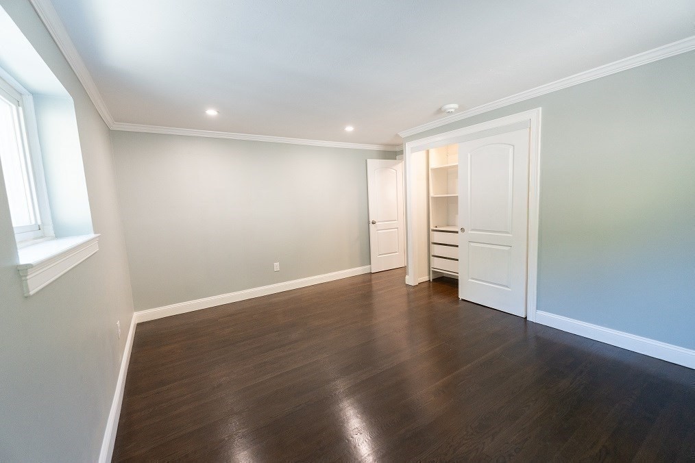 121 Tremont Street, Unit B4 Boston, MA 02135 - Photo 14 of 19 an empty room with wooden floor and windows