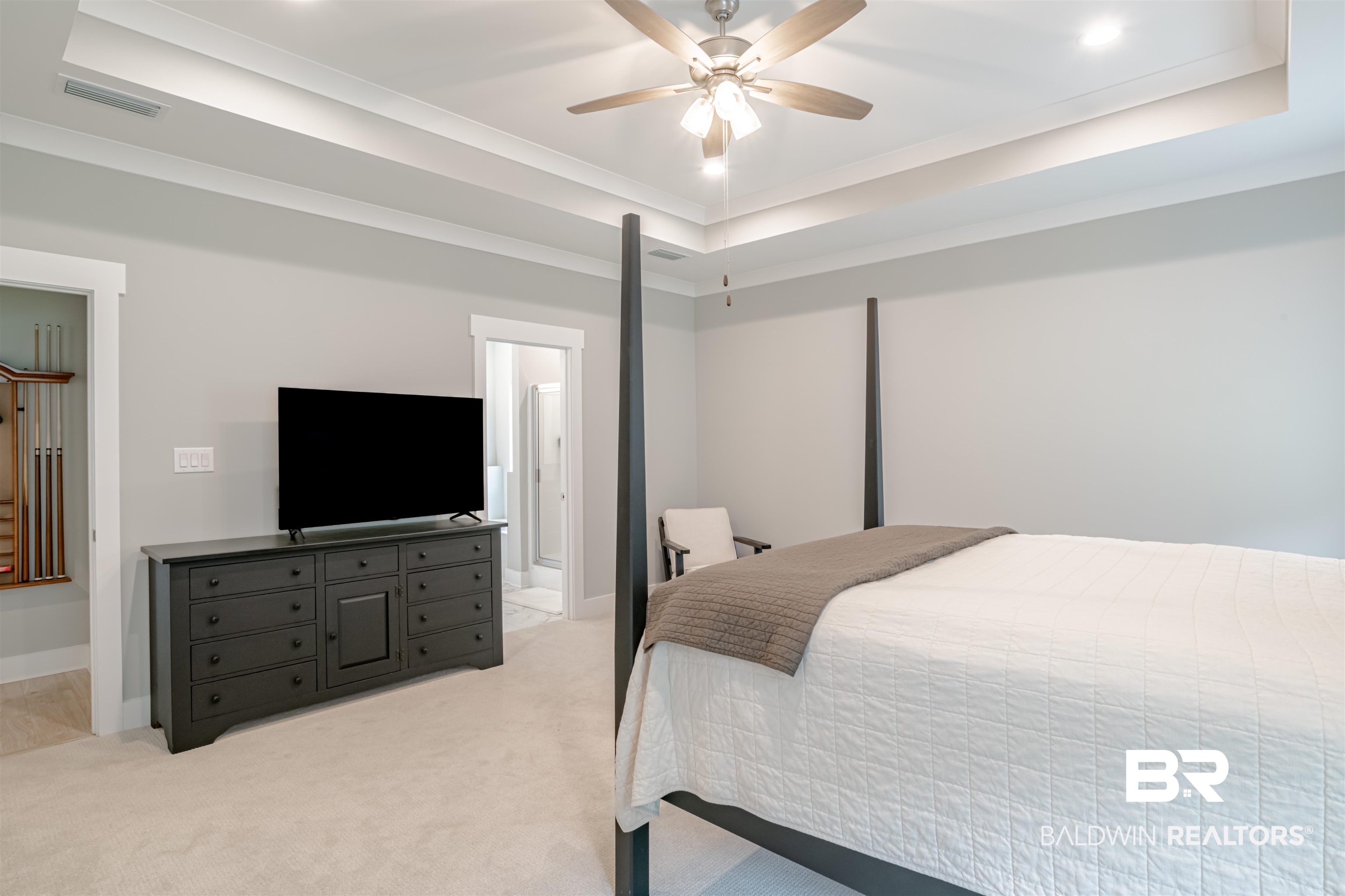655 H Norman Lane Fairhope, AL 36532 - Photo 20 of 30 Carpeted bedroom featuring a tray ceiling, ceiling fan, crown molding, and ensuite bathroom