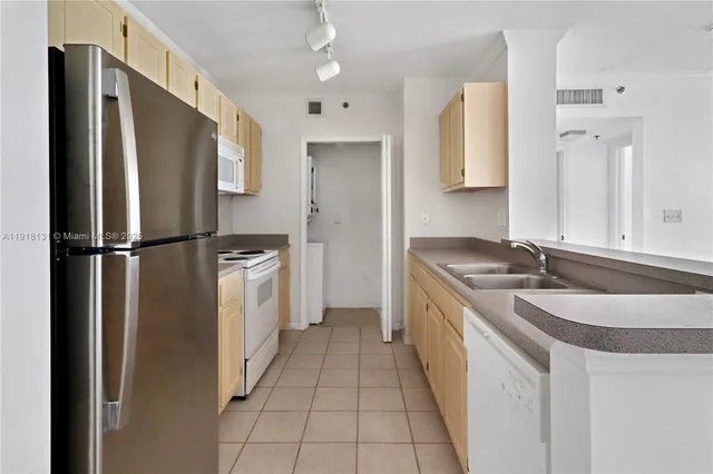 a kitchen with a sink stove and refrigerator