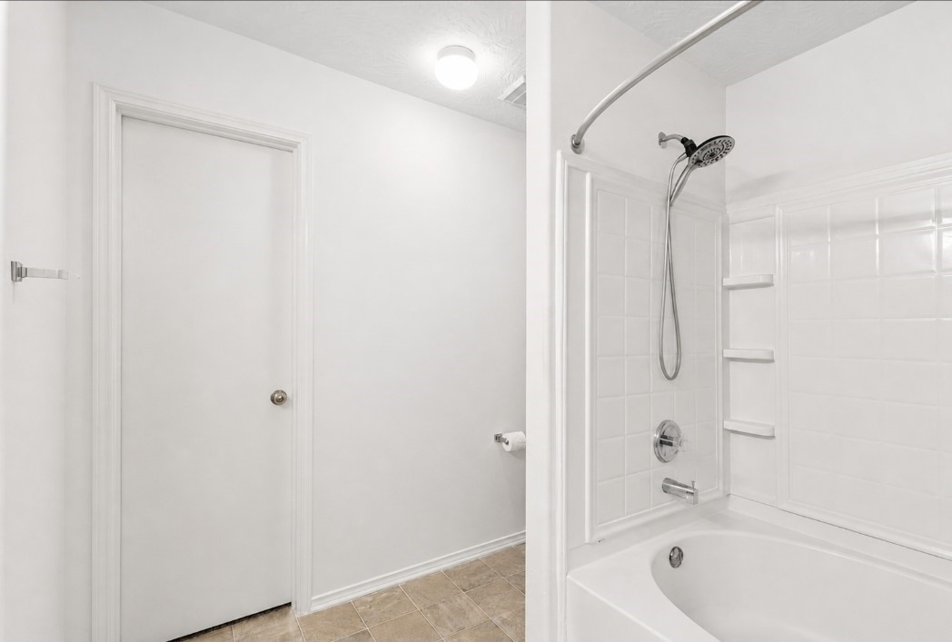 11430 Moonlight Ridge Drive Humble, TX 77396 - Photo 12 of 15 a bathroom with a bathtub and a shower
