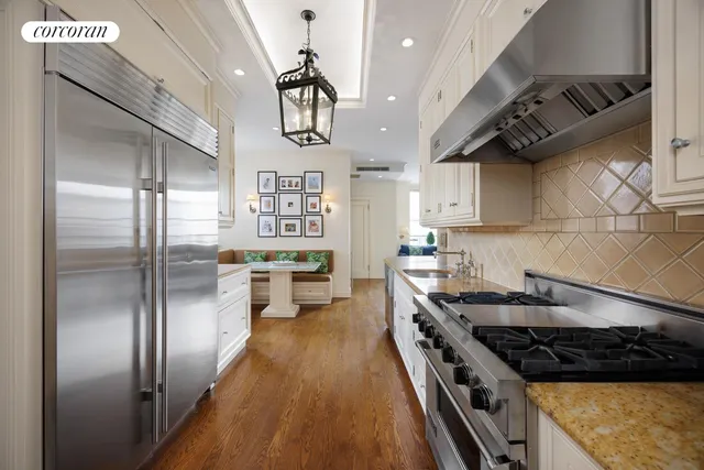 a kitchen with stainless steel appliances granite countertop a stove a refrigerator and a sink