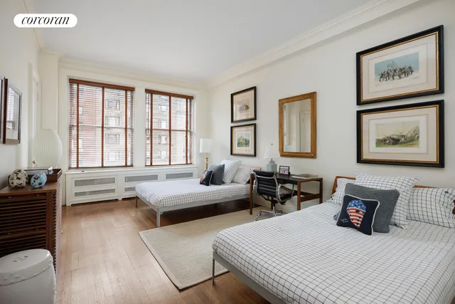 a bedroom with two beds and a couch