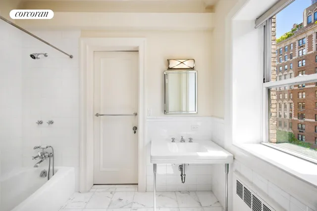 a bathroom with a sink a mirror and a bathtub