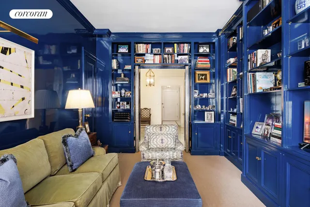 a living room with furniture and a bookshelf