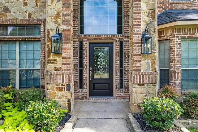 a front view of a building with a garden