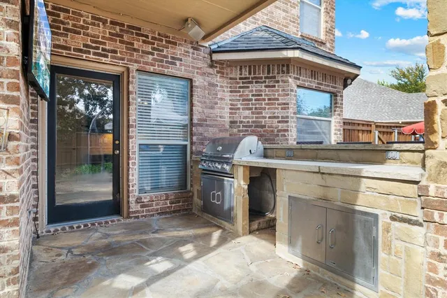 an aerial view of a house with swimming pool and a chairs