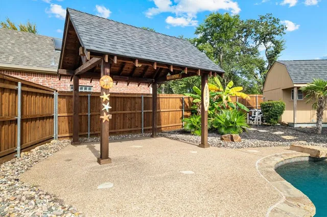 a swimming pool view with a seating space