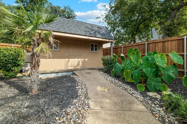 a view of a lake with a table and chairs under an umbrella