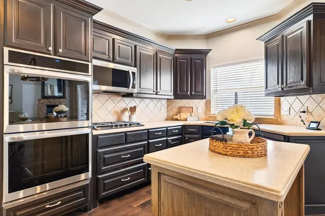 a kitchen with stainless steel appliances granite countertop a stove and a sink