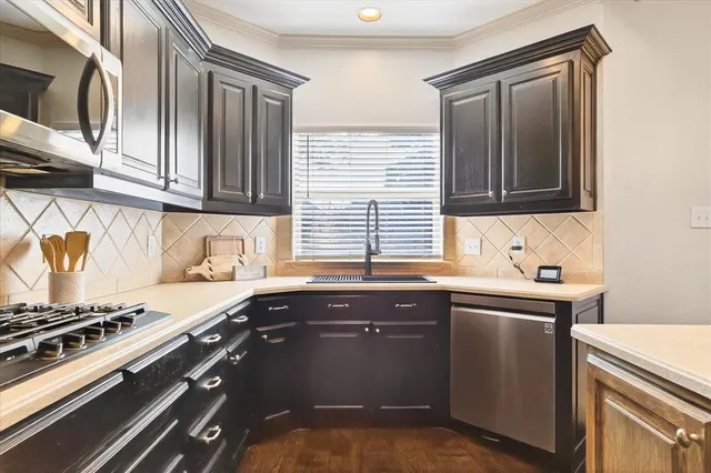 a kitchen with granite countertop a sink stove and cabinets