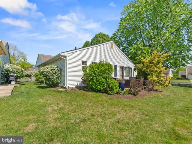 a view of a house with a yard and sitting area