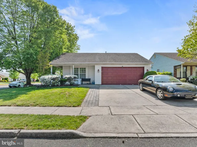 a couple of cars parked in front of a house