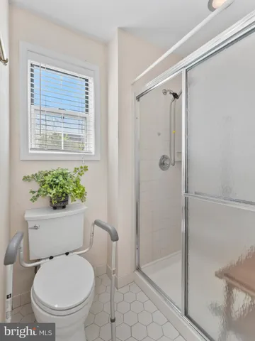 a bathroom with a toilet and a shower