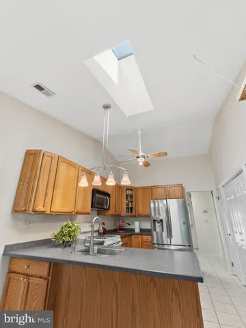 a kitchen with a sink a counter space and appliances