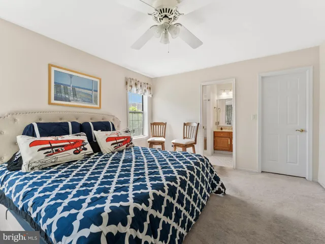 a bedroom with bed and a chandelier