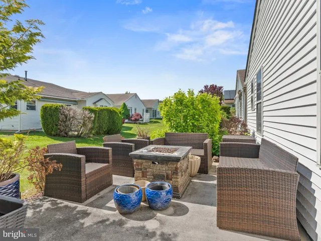 a view of a patio with couches chairs and a fire pit