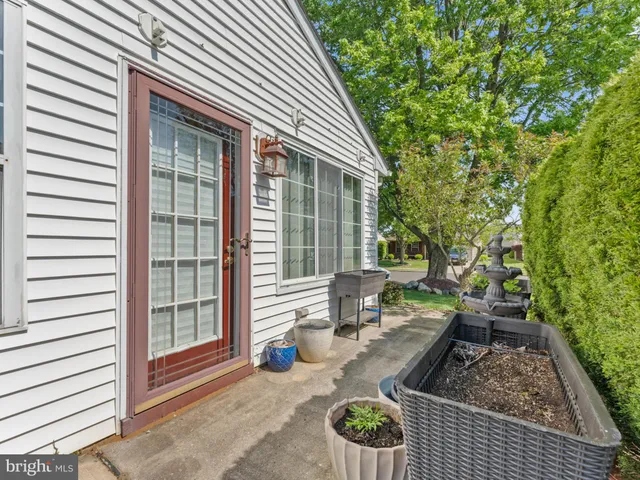 a view of a patio with couches table and chairs and potted plants