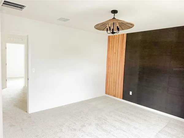 a bedroom with a chandelier fan and closet