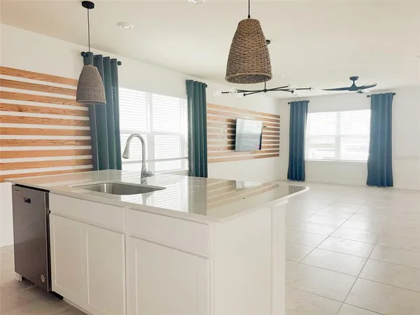 a kitchen with a sink and a refrigerator