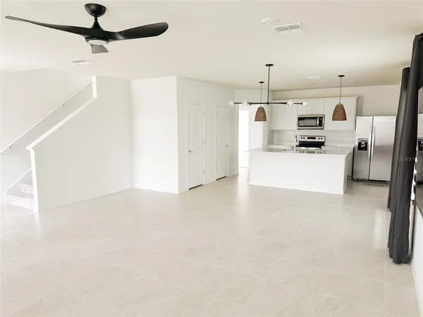 a kitchen with stainless steel appliances kitchen island a refrigerator sink and stove