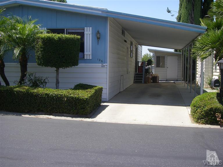 6480 Katherine Road, Unit 126 Simi Valley, CA 93063 - Photo 2 of 18 a front view of a house with garden