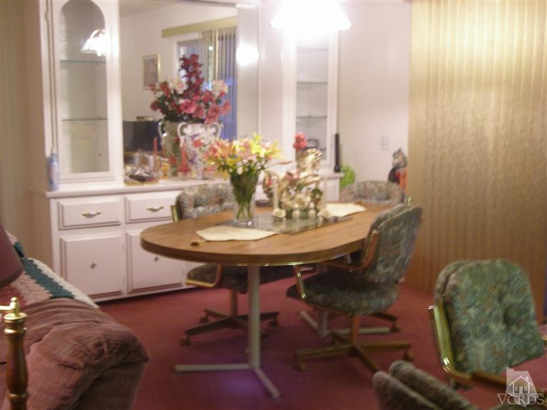 6480 Katherine Road, Unit 126 Simi Valley, CA 93063 - Photo 12 of 18 a dining room with furniture and wooden floor