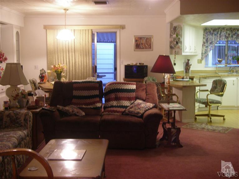 6480 Katherine Road, Unit 126 Simi Valley, CA 93063 - Photo 18 of 18 a living room with furniture and a large window