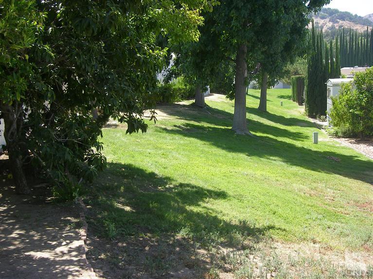 6480 Katherine Road, Unit 126 Simi Valley, CA 93063 - Photo 3 of 18 a view of a yard with a tree