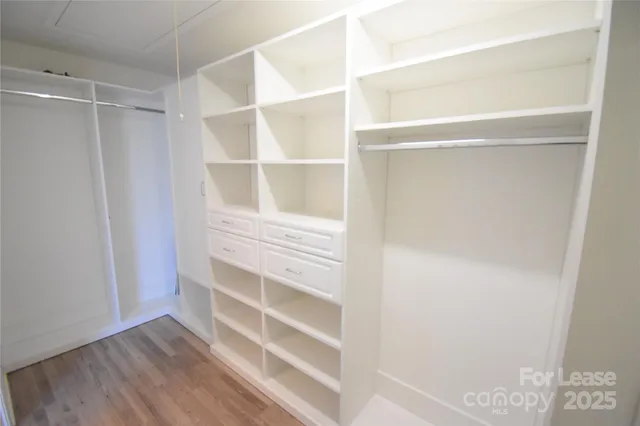 a view of walk in closet with empty racks